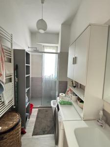 a bathroom with a sink and a washing machine at Emanuele Home in Rho