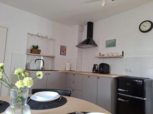 a kitchen with a table with a vase of flowers at Apartament Pod Malnikiem in Muszyna