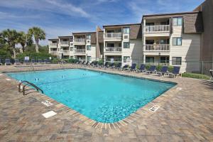 a swimming pool in front of a apartment building at Ocean Forest Villa Beach Side Oasis in Myrtle Beach