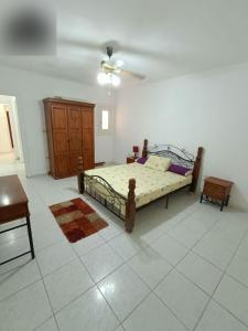 a bedroom with a bed and a dresser in it at شاليه مارينا 6 in El Alamein