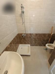 a bathroom with a toilet and a sink and a shower at شاليه مارينا 6 in El Alamein +3 photos