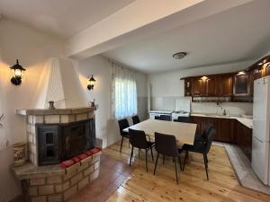 a kitchen with a table and a fireplace at Gazdinstvo Đurović in Dobra Voda