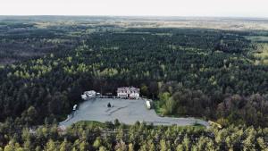 an aerial view of a house on an island in a lake at EMIDA - Restauracja & Hotel in Sinołęka