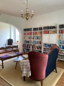 a living room with a library with book shelves filled with books at Neuensund Manor Entire Inspectors House in Neuensund