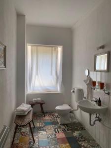 a bathroom with a toilet and a sink and a window at Neuensund Manor Entire Inspectors House in Neuensund