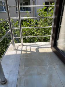 an open glass door to a balcony with trees at Istanbul Newcity Hotel in Istanbul