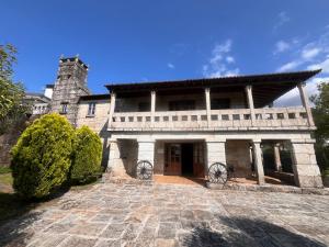 a large stone building with a tower on top at Pazo Carballo Hotel in Sampaio