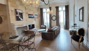 a living room with a couch and a fireplace at Burdigala Homes - Appart Duffour Dubergier in Bordeaux