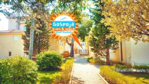 a sign that is in front of a building at Gospoja Park & Beach Apartment Vrbnik in Vrbnik