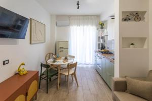 a kitchen and dining room with a table and a table and chairs at Palazzo Diana Apartment in Rossano