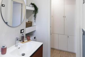 a bathroom with a sink and a mirror at Palazzo Diana Apartment in Rossano +26 photos