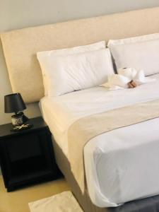 a bedroom with a bed with a teddy bear on a table at Secret-Meadow Accommodation in Maun