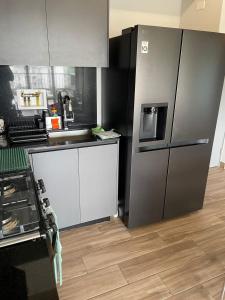a kitchen with a refrigerator and a sink at Panama Pacifico PH Downtown in El Quije