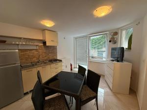 a kitchen with a table and chairs and a television at Letizia in Banjole