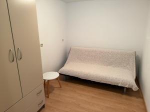 a small bedroom with a bed and a chair at Letizia in Banjole