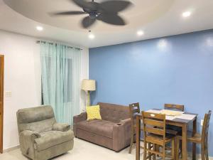 a living room with a couch and a table at Roatan Onat Hostel 1 in West End +12 photos