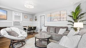a living room with a couch and a table at Modern Beach Retreat Sleeps 8 - Big Yard & BBQ in Ventnor City