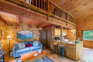a living room with a blue couch in a cabin at Pine Ridge in Sevierville