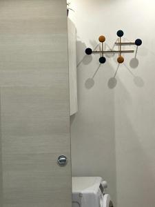a bathroom with a toilet and a chandelier on the wall at Bibi Pied-à-Terre Vetra - Two Rooms Apartment in Milan