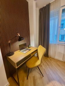a desk with a laptop and a chair in a room at Luxury apartment in the heart of Sofia in Sofia