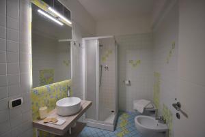 a bathroom with a shower and a sink and a toilet at Residence Il Cardellino in San Vincenzo +145 photos