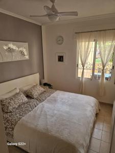 a bedroom with a bed and a ceiling fan at The Hideaway 2 Bed Poolside Groundfloor Apartment On Albatros Full AC Free Fast Wifi in Los Alcázares