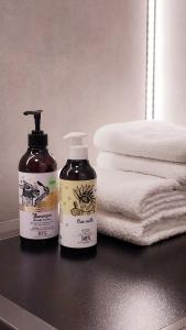 two bottles of soap on a counter with towels at Rumia Cichy Zaułek 2 in Rumia