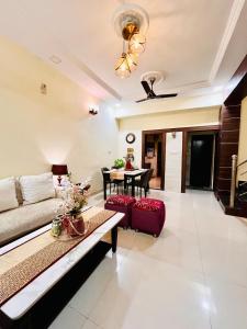 a living room with a couch and a table at The Boutique Homestay in Raipur in Raipur