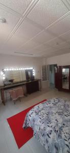 a bedroom with a bed and a desk in it at bikla f3 2nd floor in Khenchela