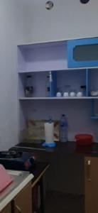 a kitchen with blue cabinets and a counter top at bikla f3 2nd floor in Khenchela