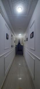a hallway in a building with a ceiling and a corridor at bikla f3 2nd floor in Khenchela