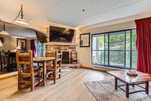 a living room with a table and chairs and a fireplace at Beaver Run Resort 4228 - Dog Friendly in Breckenridge