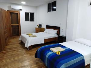 A bed or beds in a room at Hostal Darwin