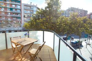 a balcony with a table and chairs and a city at New & Sunny Apartment in Barcelona
