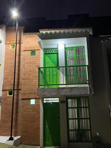 a building with two green doors and a balcony at Salento Boutique Mini House, Private, Complete in Salento