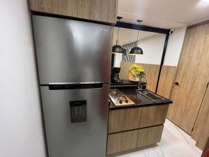 a kitchen with a stainless steel refrigerator and a sink at Salento Boutique Mini House, Private, Complete in Salento
