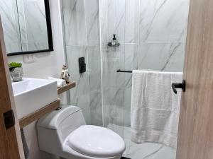 a white bathroom with a toilet and a sink at Salento Boutique Mini House, Private, Complete in Salento