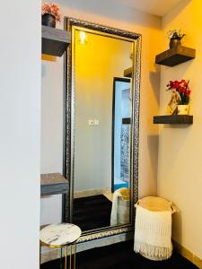 a mirror in a room with a stool in front of it at Silver Homes 2 bedroom nt in Kampala +6 photos