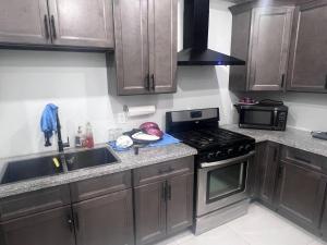 a kitchen with wooden cabinets and a stove top oven at B12 Private Room In Cambridge in Cambridge