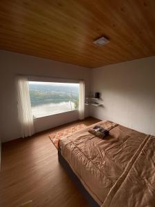 Postel nebo postele na pokoji v ubytování Glamping Telaga Menjer Lantai 7