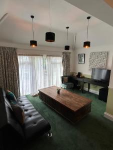 a living room with a couch and a table at Barons Court Hotel in Wolverhampton