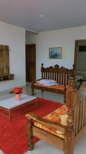 a room with two beds and a red rug at Casa em Salinas Pá in Salinópolis