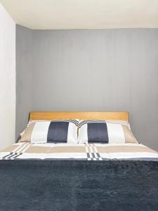 a bed with two pillows on it in a bedroom at Room Airport in Bogotá