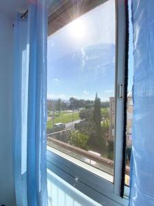 a window with a view of a street at Premium Haim apt in Haifa +23 photos