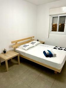 a bedroom with a bed and a window at Premium Haim apt in Haifa