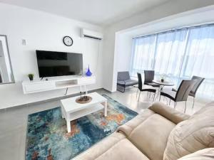 a living room with a couch and a tv at Premium Haim apt in Haifa