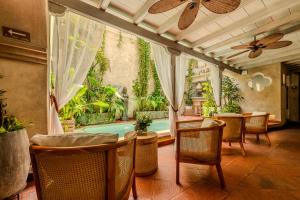 a patio with a pool and chairs and a table at Moet Cartagena Hotel Boutique Adutls Only in Cartagena de Indias
