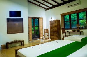 A bed or beds in a room at Garcinia Leaf