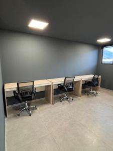 an office with two desks with chairs and a window at Ora Beach 108 Porto de Galinhas in Porto De Galinhas +55 photos