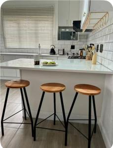 a kitchen with a counter and two stools at 4beds,3 bedrooms,Braai,Full kitchen in Tzaneen +11 photos